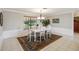 Elegant dining room featuring natural light from the large window, crown molding, and tiled flooring at 534 Minnow Ct, Kenansville, FL 34739