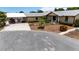 Single-story home featuring well-kept landscaping, a metal roof, and a paved driveway in a tranquil neighborhood at 534 Minnow Ct, Kenansville, FL 34739