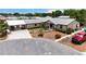 Charming single-story home with a metal roof, landscaped yard, and paved driveway in a waterfront community at 534 Minnow Ct, Kenansville, FL 34739