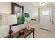 Inviting foyer features a console table, decorative mirror, and tiled flooring at 534 Minnow Ct, Kenansville, FL 34739