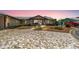 Charming home boasts a unique, patterned driveway with lush landscaping and a cozy front porch at 534 Minnow Ct, Kenansville, FL 34739