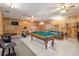 Game room with a pool table, wood-paneled walls, tiled flooring, and exercise bike at 534 Minnow Ct, Kenansville, FL 34739