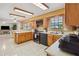 Open kitchen features wooden cabinets, black appliances, and a breakfast bar at 534 Minnow Ct, Kenansville, FL 34739