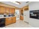 Traditional kitchen with wood cabinets, tile backsplash, and stainless steel appliances at 534 Minnow Ct, Kenansville, FL 34739
