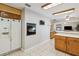 Bright kitchen features neutral tile floors, wooden cabinetry and built-in oven at 534 Minnow Ct, Kenansville, FL 34739