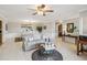Spacious living room open to the dining area with a decorative rug and stylish furnishings at 534 Minnow Ct, Kenansville, FL 34739