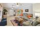 Bright and inviting living room with a comfortable sofa and access to the dining area at 534 Minnow Ct, Kenansville, FL 34739