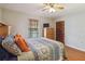 Comfortable main bedroom with hardwood floors, ceiling fan, and closet at 534 Minnow Ct, Kenansville, FL 34739