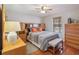 Main bedroom with hardwood floors, ceiling fan, and ample storage space at 534 Minnow Ct, Kenansville, FL 34739