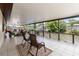 Long, covered patio with tiled floor, decorative railing, and relaxing seating area at 534 Minnow Ct, Kenansville, FL 34739