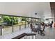 Spacious covered patio with tiled floor and decorative railing overlooking the canal at 534 Minnow Ct, Kenansville, FL 34739