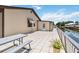 Back of house with tiled patio and railing facing canal at 534 Minnow Ct, Kenansville, FL 34739