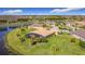 Aerial view of home near lake with screened in lanai, palms, and desert landscaping at 551 San Raphael St, Kissimmee, FL 34759