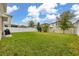 Spacious backyard with lush grass and view of the surrounding community at 5685 Surprise Lily Dr, Winter Garden, FL 34787
