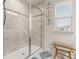 Bathroom featuring a glass-enclosed walk-in shower, tiled walls, and a window letting in natural light at 5685 Surprise Lily Dr, Winter Garden, FL 34787