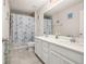 Bathroom featuring double sinks, white cabinets, and a shower-tub combo at 5685 Surprise Lily Dr, Winter Garden, FL 34787
