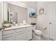 Clean bathroom with a white vanity, modern toilet, and decorative accents at 5685 Surprise Lily Dr, Winter Garden, FL 34787