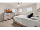 Bedroom featuring neutral walls, a ceiling fan, and two windows for natural light at 5685 Surprise Lily Dr, Winter Garden, FL 34787