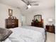 Comfortable bedroom featuring a ceiling fan, dark wood furnishings and neutral color palette at 5685 Surprise Lily Dr, Winter Garden, FL 34787
