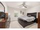 Serene bedroom featuring a ceiling fan, dark wood furnishings and neutral color palette at 5685 Surprise Lily Dr, Winter Garden, FL 34787