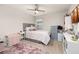 Cozy bedroom featuring neutral tones, plush rug, ceiling fan and comfortable decor at 5685 Surprise Lily Dr, Winter Garden, FL 34787