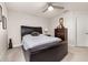 Relaxing bedroom featuring a ceiling fan, dark wood furnishings and neutral color palette at 5685 Surprise Lily Dr, Winter Garden, FL 34787