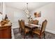 Bright dining room featuring a wooden table with upholstered chairs and a modern chandelier at 5685 Surprise Lily Dr, Winter Garden, FL 34787