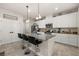 Stylish kitchen with white cabinetry, granite countertops, stainless appliances, and a breakfast bar at 5685 Surprise Lily Dr, Winter Garden, FL 34787