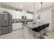 Well-lit kitchen featuring stainless steel appliances, white cabinets, and granite countertops at 5685 Surprise Lily Dr, Winter Garden, FL 34787