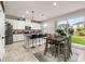 Bright kitchen featuring white cabinets, stainless steel appliances, and a breakfast bar with seating at 5685 Surprise Lily Dr, Winter Garden, FL 34787