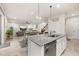 Open concept kitchen with granite countertops, stainless steel appliances, and eat-in seating overlooking the living area at 5685 Surprise Lily Dr, Winter Garden, FL 34787