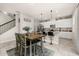 Modern kitchen with white cabinets, stainless steel appliances, and an island with bar stools at 5685 Surprise Lily Dr, Winter Garden, FL 34787