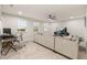 Large living room with a comfortable sofa and an entertainment area with an adjacent office space at 5685 Surprise Lily Dr, Winter Garden, FL 34787