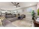 Open-concept living room with a sectional sofa, tile flooring, and lots of natural light at 5685 Surprise Lily Dr, Winter Garden, FL 34787