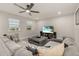 Upstairs living room with comfortable seating, ceiling fan and a large television at 5685 Surprise Lily Dr, Winter Garden, FL 34787