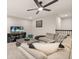 Upstairs living room with comfortable seating, ceiling fan and a large television at 5685 Surprise Lily Dr, Winter Garden, FL 34787