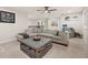 Spacious upstairs living room featuring a large sofa, ceiling fan and a desk area at 5685 Surprise Lily Dr, Winter Garden, FL 34787