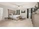 This main bedroom boasts an elegant ceiling fan, decorative furnishings, and soothing natural light at 5685 Surprise Lily Dr, Winter Garden, FL 34787