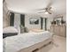 Relax in this main bedroom featuring neutral paint, a ceiling fan, and a decorative dresser at 5685 Surprise Lily Dr, Winter Garden, FL 34787