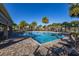 Beautiful community pool surrounded by palm trees and lounge seating at 5685 Surprise Lily Dr, Winter Garden, FL 34787