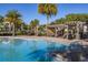 Inviting community pool area with shaded pergola and lounge chairs at 5685 Surprise Lily Dr, Winter Garden, FL 34787