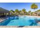 Large, inviting community pool surrounded by lush landscaping and seating at 5685 Surprise Lily Dr, Winter Garden, FL 34787