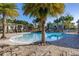Community pool with palm trees and lounge chairs at 5685 Surprise Lily Dr, Winter Garden, FL 34787
