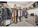 Organize your wardrobe in this walk-in closet with ample hanging space and storage shelves at 5685 Surprise Lily Dr, Winter Garden, FL 34787
