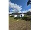 View of the back of the home and the backyard, showcasing the spacious lawn at 6 Bahia Course Ln, Ocala, FL 34472