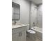 Newly renovated bathroom features a vanity, toilet, and white marble tiled tub-shower combo at 6 Bahia Course Ln, Ocala, FL 34472