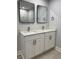 Bathroom showcasing a vanity with double sinks and framed mirrors at 6 Bahia Course Ln, Ocala, FL 34472