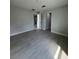 Spacious bedroom featuring modern gray flooring and light gray walls at 6 Bahia Course Ln, Ocala, FL 34472