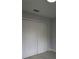 Bedroom with a four-panel closet door and neutral paint for a clean aesthetic at 6 Bahia Course Ln, Ocala, FL 34472