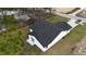 Aerial shot of the home's exterior, showing the backyard, dark grey roof, and driveway at 6 Bahia Course Ln, Ocala, FL 34472